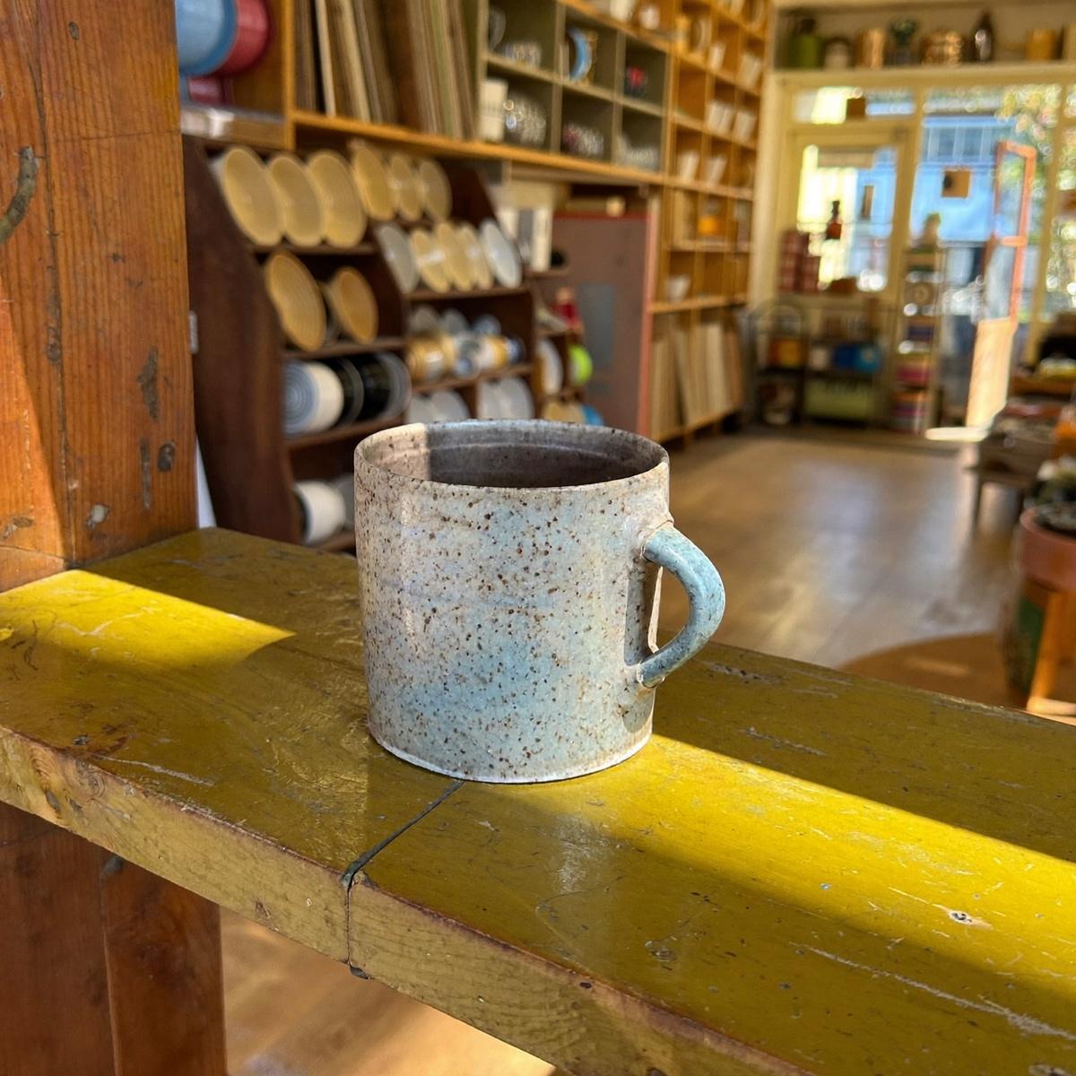 A speckled stoneware mug.