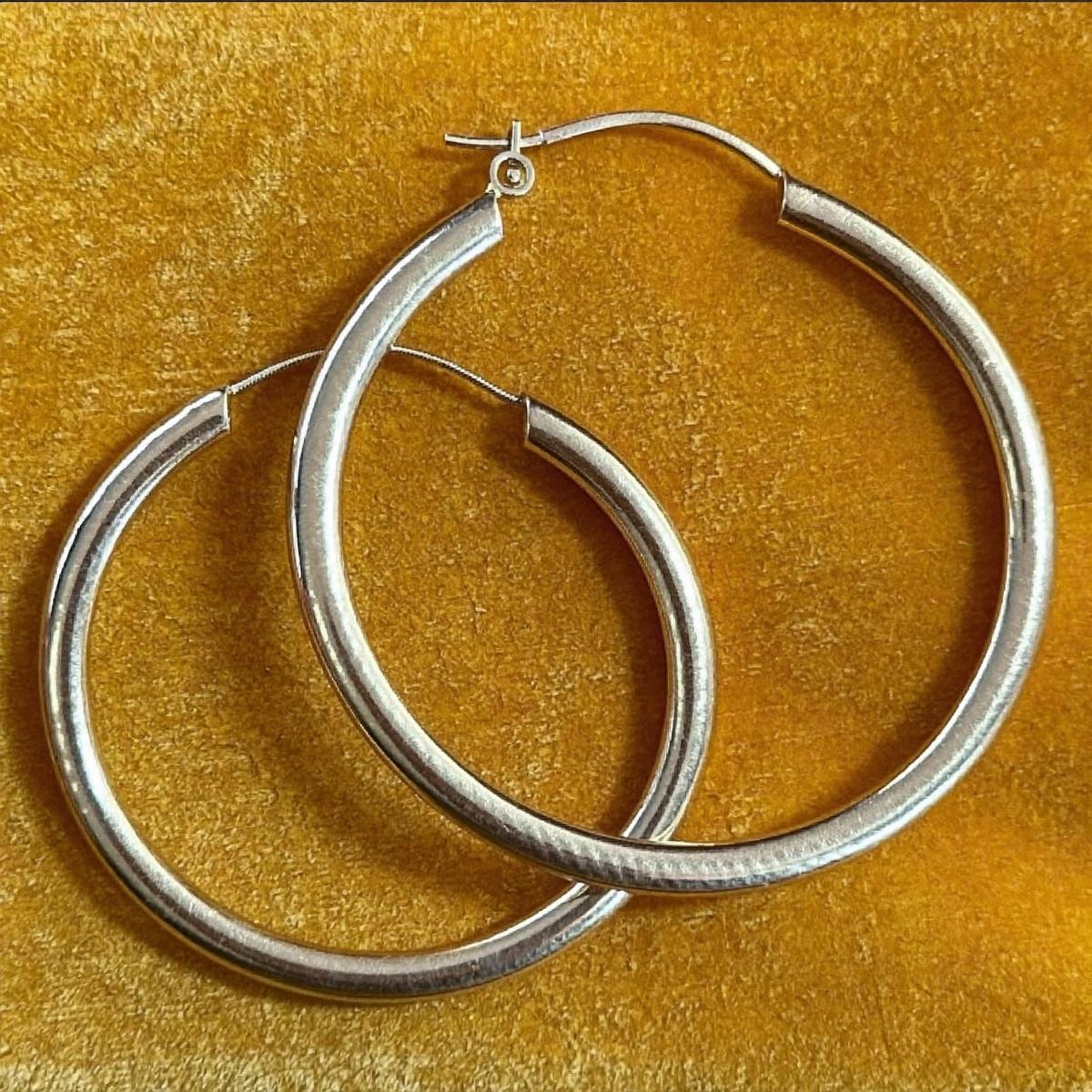 A pair of gold hoop earrings.