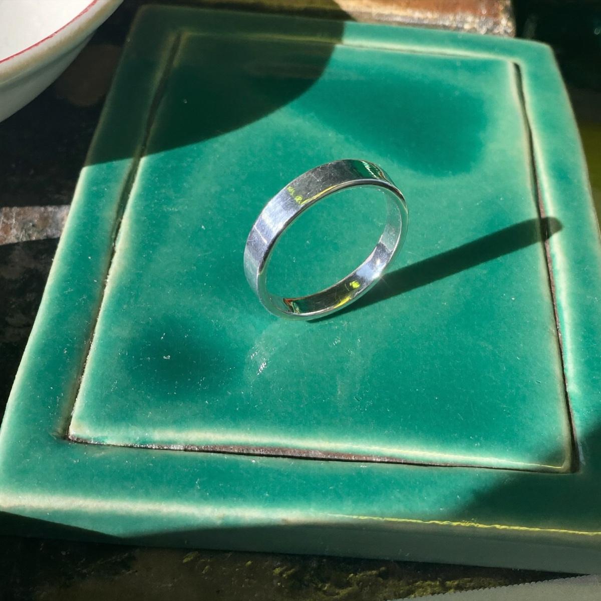 A plain silver band ring.