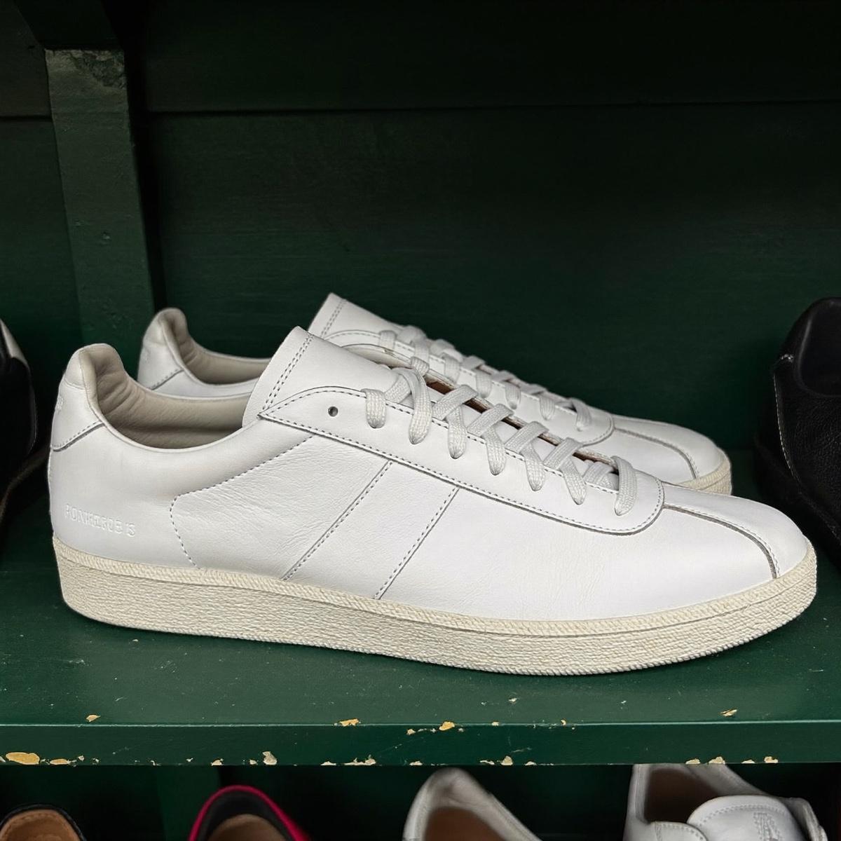 A pair of white leather sneakers.