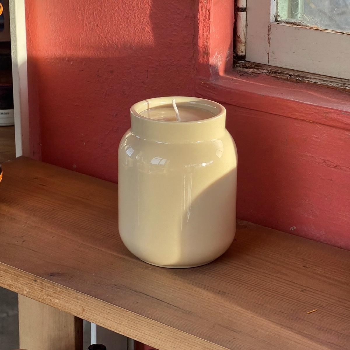 A ceramic jar soy candle.